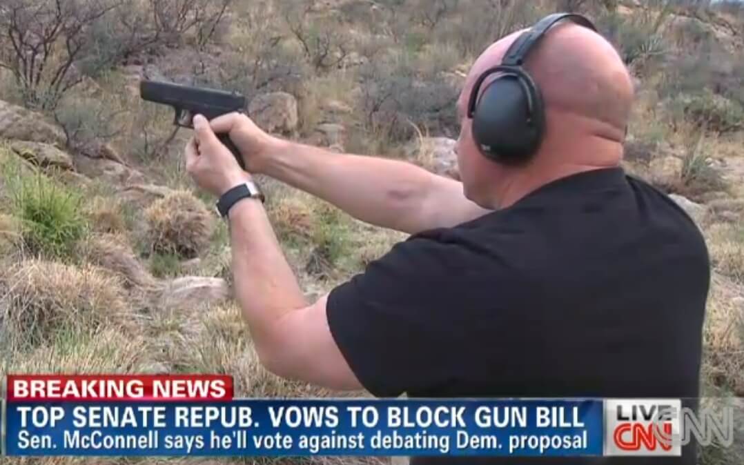 Mark Kelly on CNN in 2013 with his wife's Glock 9mm, the same kind of gun his wife was shot with